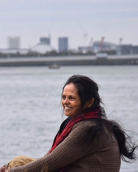Portrait of Jamuna Rijal smiling beside the water